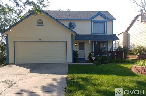 A two-story house with a garage and a blue trim.