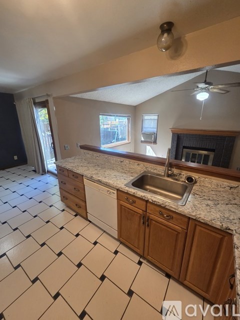 A kitchen with a sink and a window.