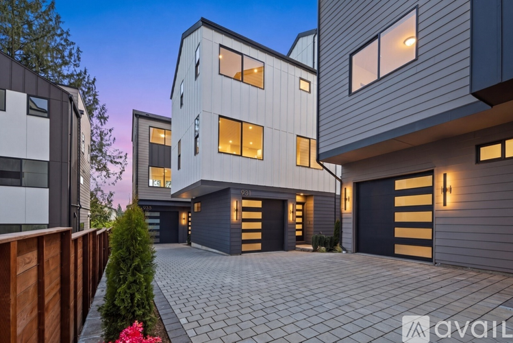A modern house with a driveway and garage doors.