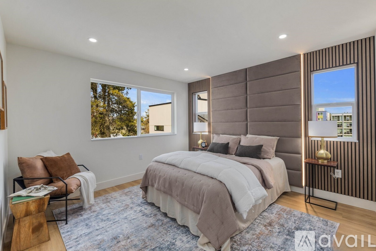 A bedroom with a large bed and a view of the city.