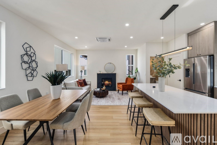 A modern dining room with a wooden table and chairs.