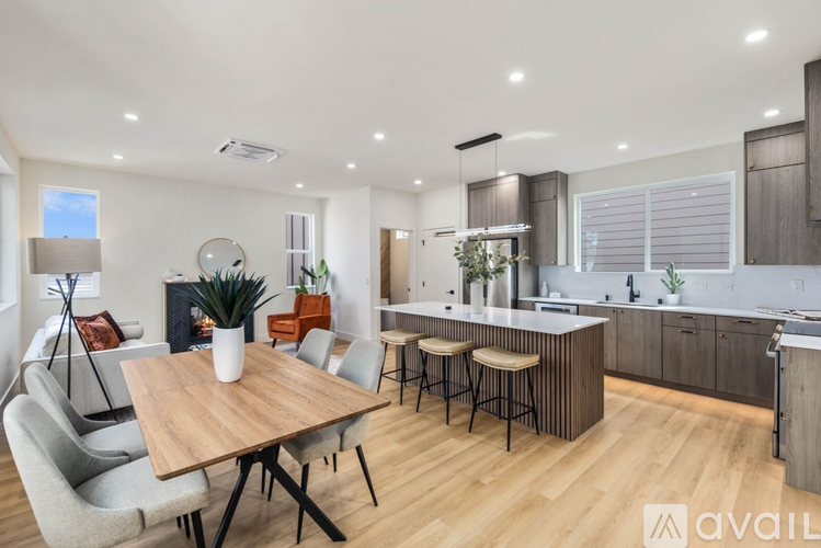 A modern kitchen with a dining table and chairs.