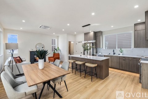 A modern kitchen with a dining table and chairs.