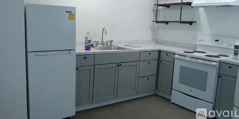 A kitchen with a white fridge and a white stove.