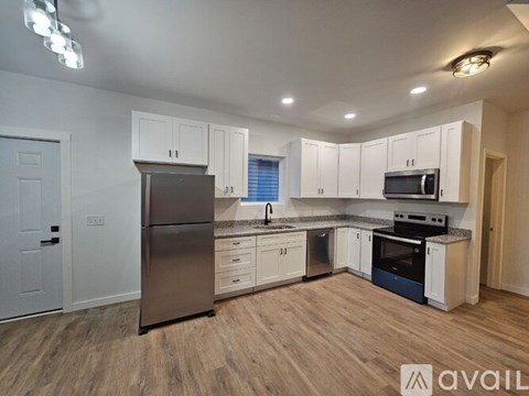 A kitchen with white cabinets and stainless steel appliances.