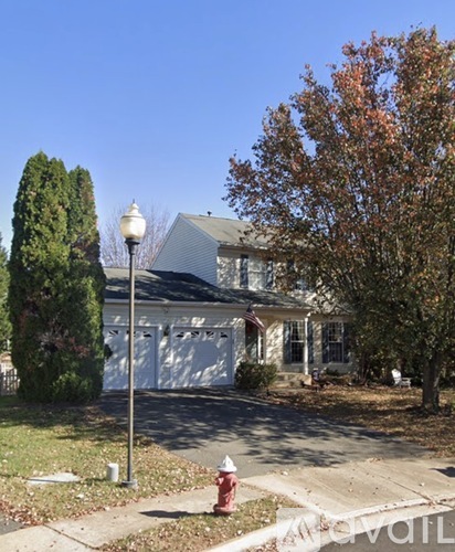 A house with a red fire hydrant in front of it.