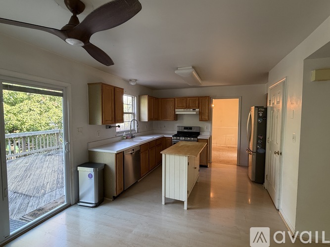 A kitchen with a fan and a dishwasher.