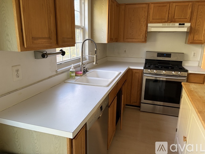 A kitchen with wooden cabinets and a white countertop.