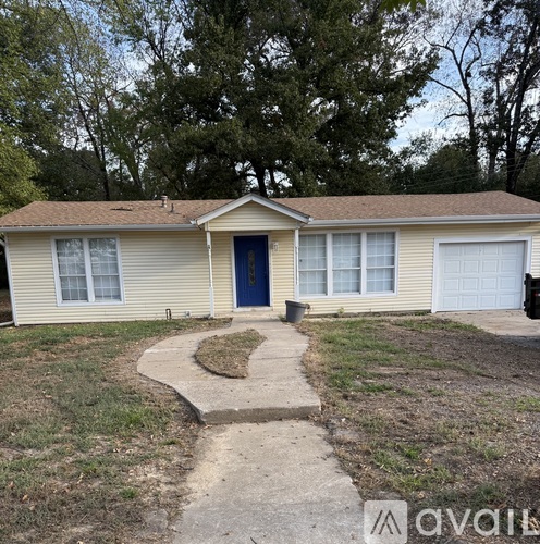 A house with a blue door and a brown roof.