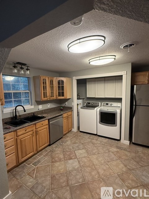 A kitchen with brown cabinets and a white oven.