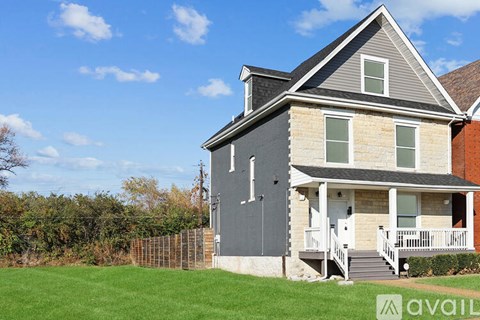 A house with a grey exterior and a white porch.