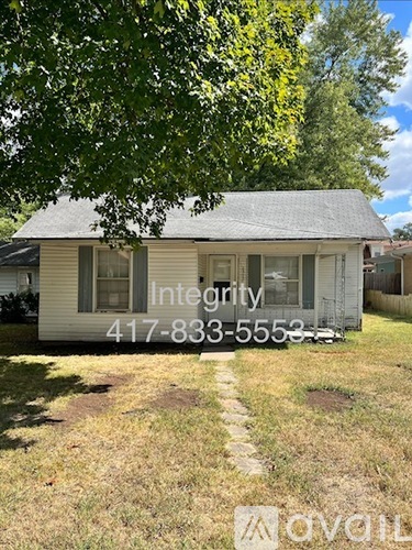 A house with the word "Integrity" written on it and a phone number.