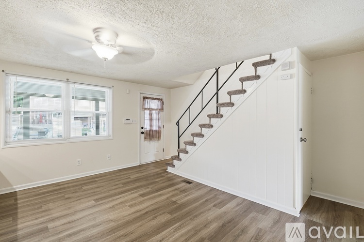 A room with a staircase and a window.