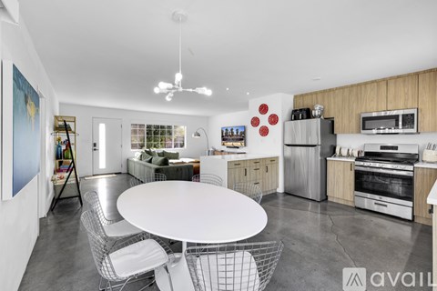 A modern kitchen with a dining table and chairs.
