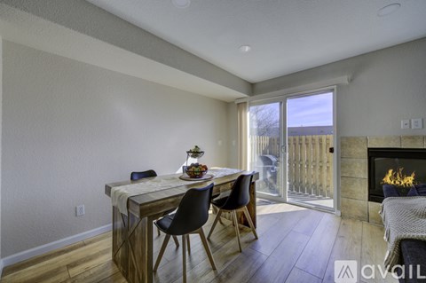 A dining area with a table and chairs is shown.