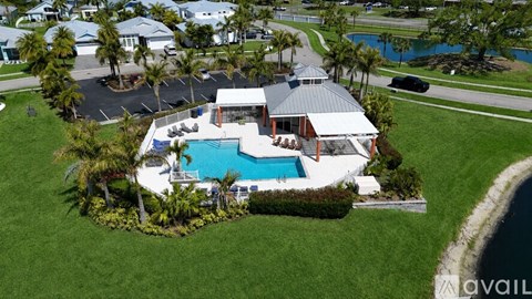 A house with a pool surrounded by greenery.