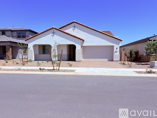 A white house with a brown roof is available for sale.