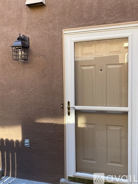 A white door with a glass window is open.
