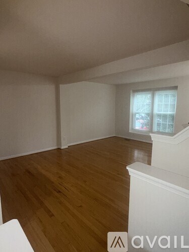 A room with wooden floors and white walls.