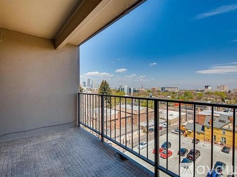 A balcony with a view of a city skyline.