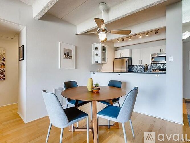 A dining room with a table and chairs.