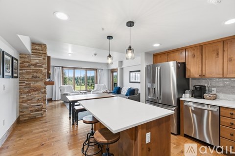 A modern kitchen with wooden cabinets and a large island.