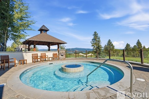 A small pool with a hot tub in the middle of it.