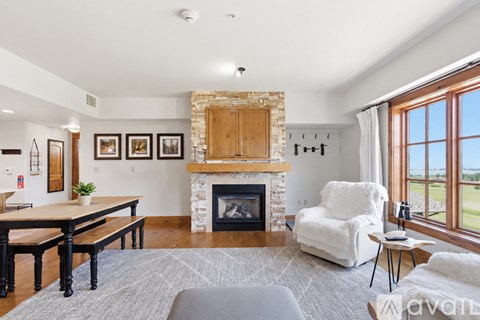A living room with a fireplace and a chair.