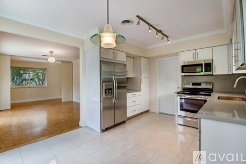 A kitchen with white cabinets and stainless steel appliances.
