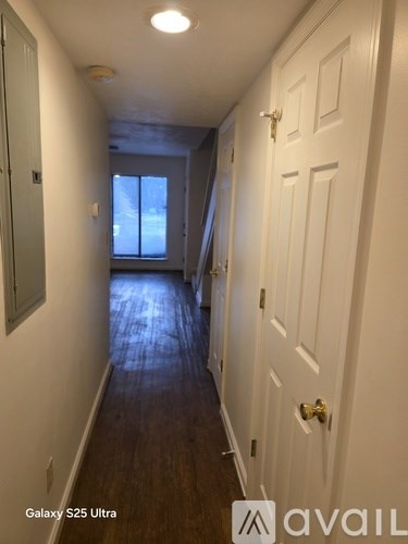 A long hallway with a door on the right.