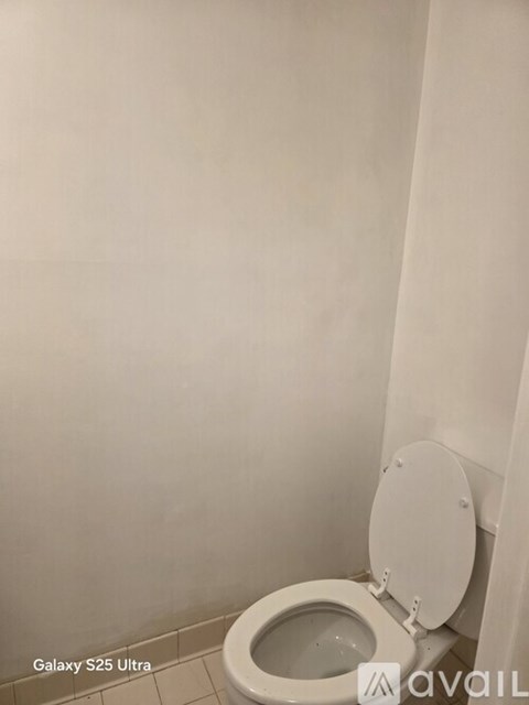 A white toilet with the text "Galaxy S25 Ultra" and "Avail" on the wall.