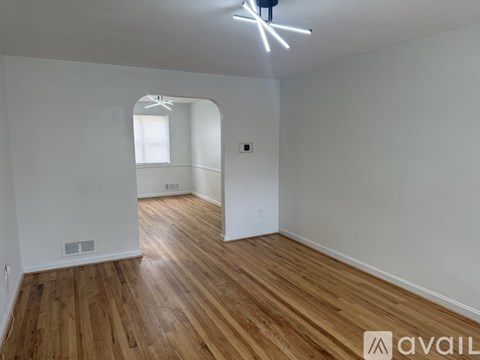 A room with wooden floors and a window.