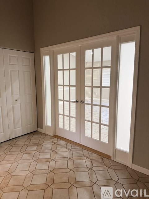 A room with a tiled floor and a white door.