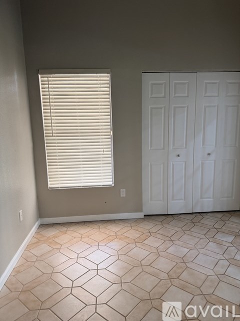 A room with a tile floor and a white door.