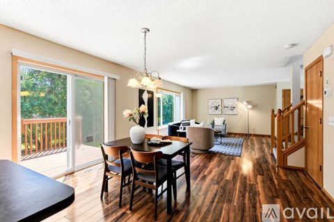 A dining room with a wooden table and chairs.