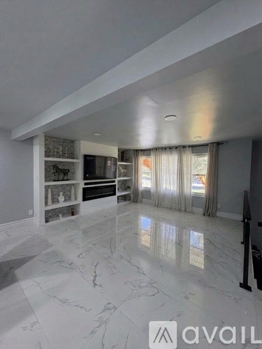 A living room with a grey couch and a coffee table.