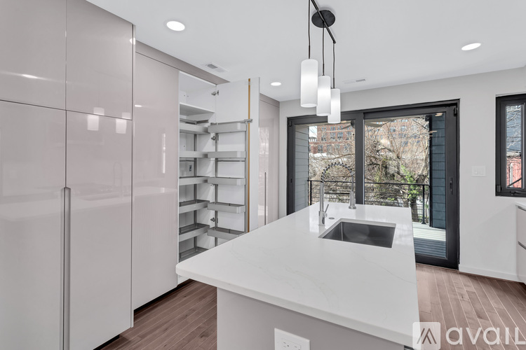 A modern kitchen with white cabinets and a large island.