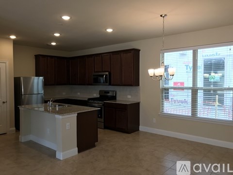 A kitchen with brown cabinets and a white island.