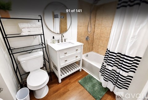 A white bathroom with a toilet, sink, and bathtub.