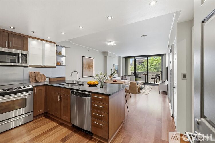 A modern kitchen with wooden cabinets and stainless steel appliances.