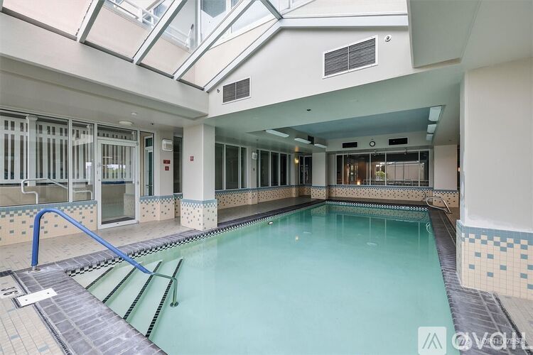 A large indoor swimming pool with a skylight above it.