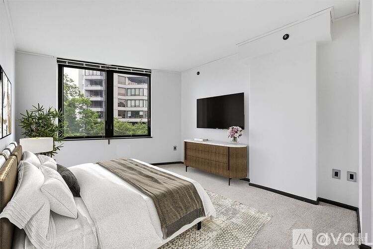 A bedroom with a large bed and a flat screen TV.