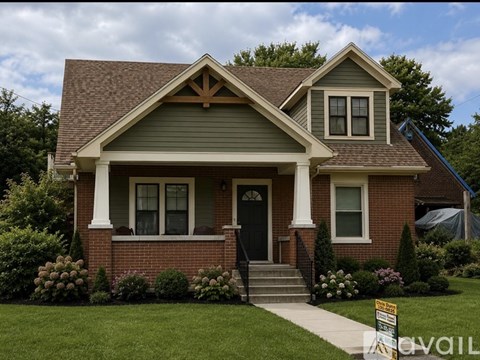 A house with a brown roof and a black front door.