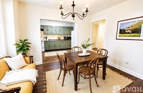 A dining room with a wooden table and chairs.