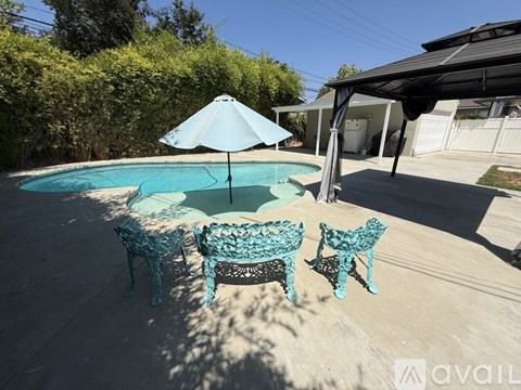 A pool with a table and chairs around it.