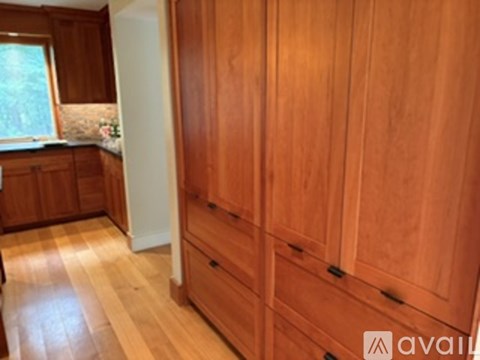 A wooden floor and cabinet in a kitchen.