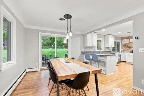 A dining area with a table and chairs is shown in the image.