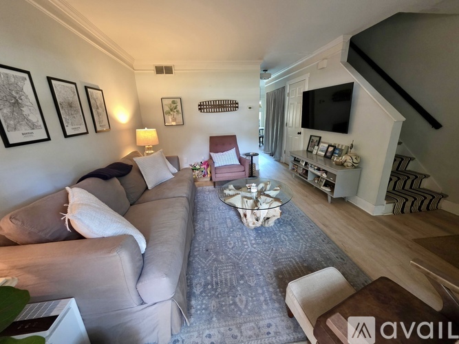 A living room with a grey couch and a coffee table in the middle.