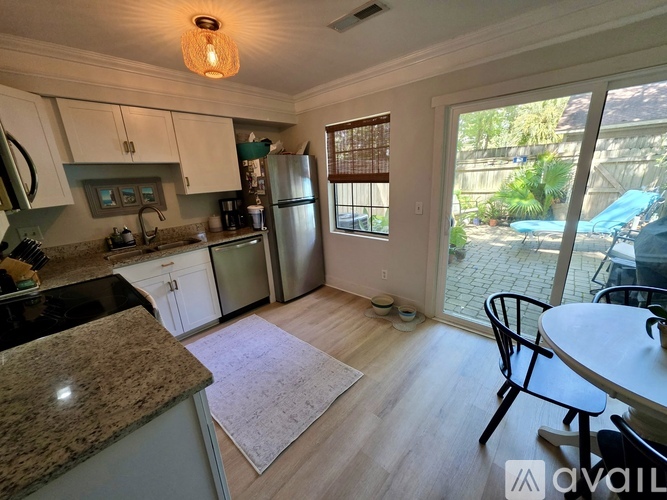 A kitchen with granite countertops and stainless steel appliances.