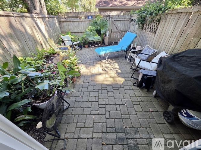 A backyard with a pool table and patio furniture.